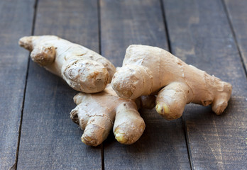 Fresh ginger root on wooden table