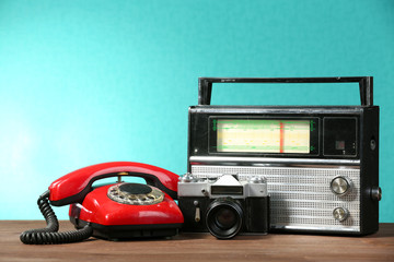 Old retro radio on table on green wall background