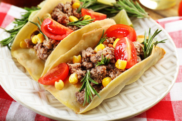 Mexican food Tacos in plate on napkin, closeup