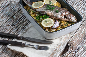 Baked trout with potatoes.