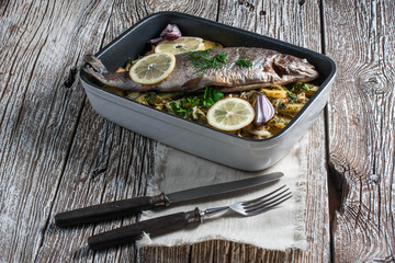 Baked trout with potatoes.