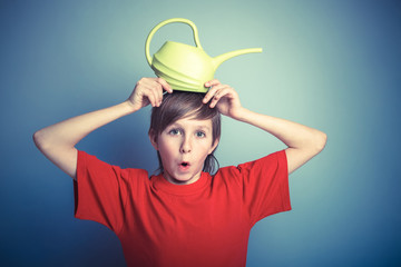 European-looking boy of twelve years from the watering can on hi