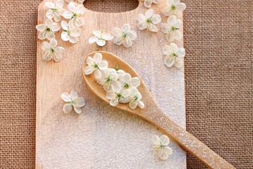 Wooden kitchen utensil flour spring blossom culinary background 