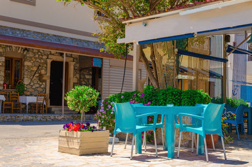 Fototapeta na wymiar Traditional Greek restaurant with blue chairs on Kalymnos Island