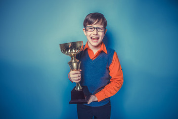 European-looking  boy of  ten years  in glasses holding a cup, a