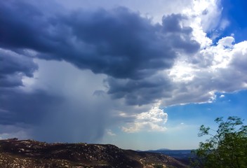 summer storm over rolling hills