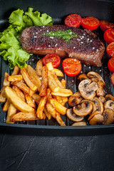 Fried steak with fries .