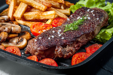Fried steak with fries .