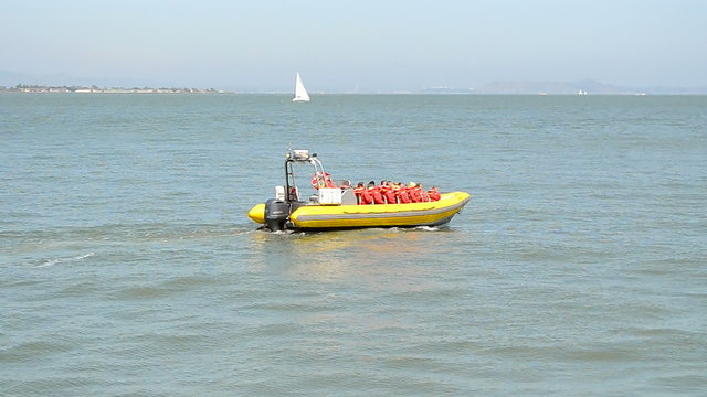 yellow resque vessel (boat) on the azure sea waves in sunny day, travel diversity 