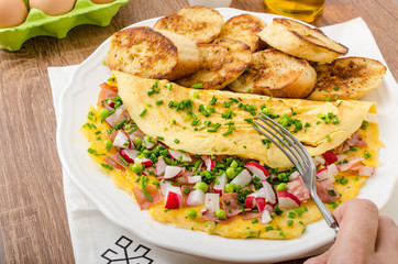 Omelette with spring vegetables and bacon