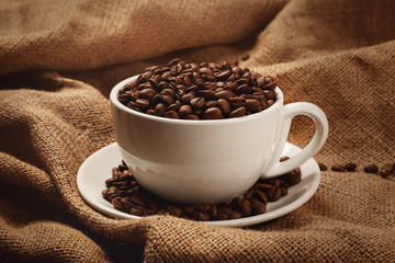 Cup filled with coffee beans