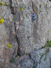 Beautiful man climbs a high mountain.