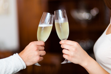 Man and Woman hands toasting with Champagne
