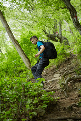 Naklejka na ściany i meble Teenager hiker on a mountain trail
