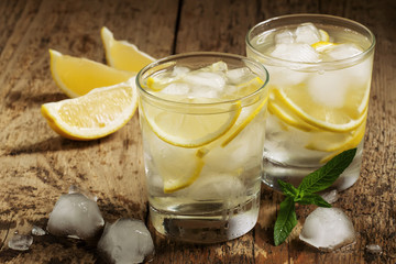 Fresh water with lemon, mint and ice, selective focus