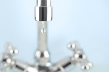 tap and his reflection in a single drop of water