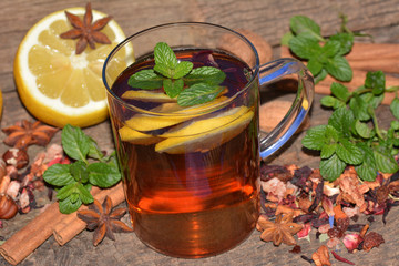 Tea with pieces of dried fruit, lemon and mint
