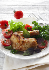 Roasted chicken leg with herbs and salad