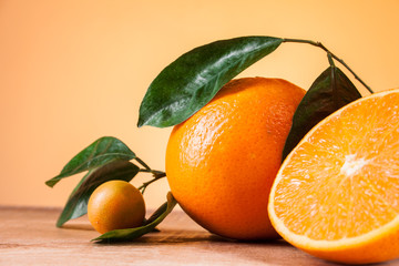 Oranges with shoots on a wooden table