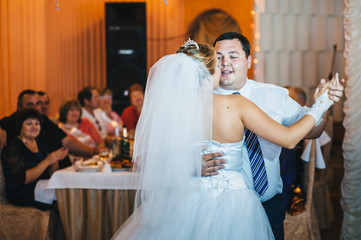 beautiful caucasian couple just married and dancing their first