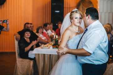 beautiful caucasian couple just married and dancing their first