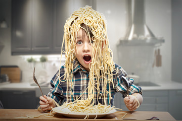 Surprised boy with pasta on the head - obrazy, fototapety, plakaty
