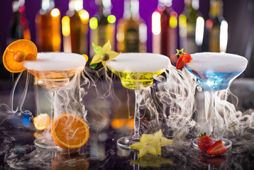 Cocktails with ice vapor on bar desk
