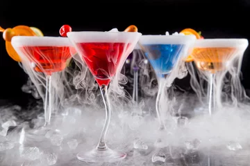 Fotobehang Cocktails with ice vapor on bar desk © Lukas Gojda