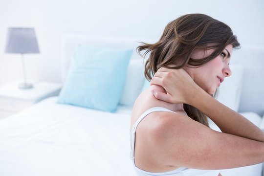 Pretty woman suffering from neck pain 
