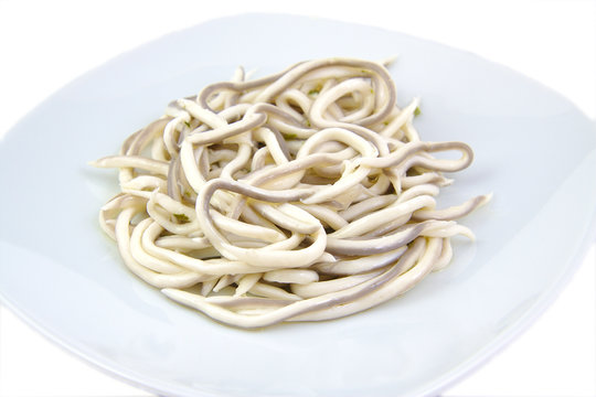 Baby eels or elver substitute in garlic sauce. Traditional