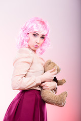 childlike woman with teddy bear toy