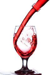 splash of wine in the cup filling on a white background