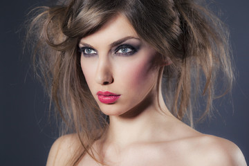 Fototapeta premium Portrait of a beautiful woman with make-up and messy hair