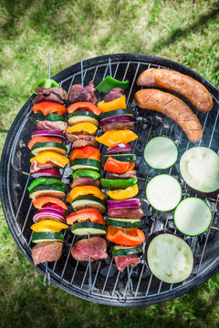 Roasting fresh beef and vegetables with spices in garden