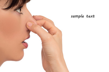 Fototapeta premium Image with woman's face holding her nose with hand