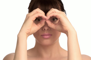 Woman's face hold hands as binoculars