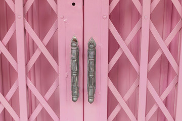 pink old steel door in home of thailand