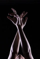 The outline of a beautiful female hand on a black background