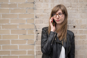 Young caucasian woman in city talking on cell phone