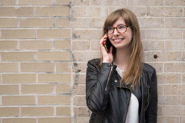 Young caucasian woman in city talking on cell phone