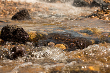 The movement of water on the rocks.