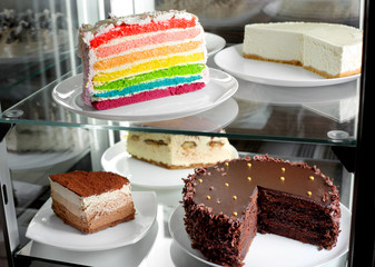 Fridge with fruit cake and desserts