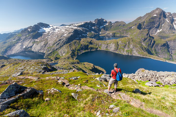 Naklejka premium Man takes rest on top of mountain in Norway