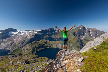 Woman takes rest on top of mountain in Norway