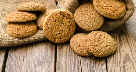 Oatmeal cookies with wooden background