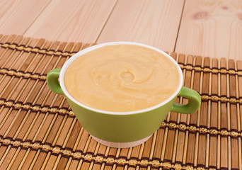 Pea soup in a green bowl.