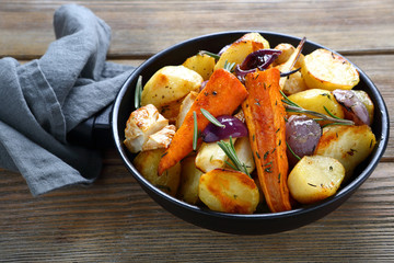 Oven-baked vegetables pieces with herbs