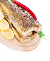 Fried carp tail with lemon and pepper.