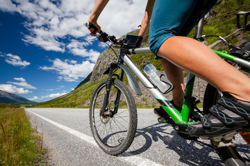 Fototapeta na wymiar Biking in Norway against picturesque landscape
