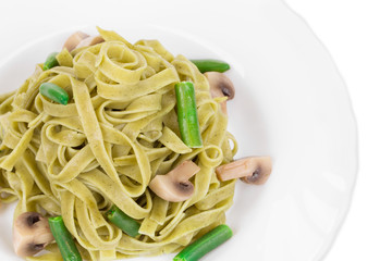 Pasta tagliatelle with green peas and ham.